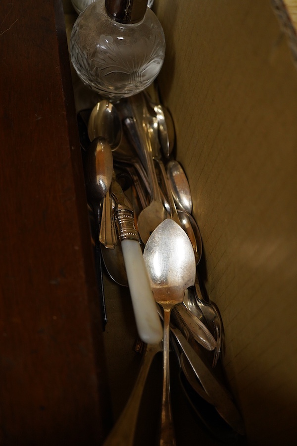 A cased set of twelve pairs of mother of pearl handled plated dessert eaters and a quantity of assorted plated items including a toastrack, a pair of mounted glass condiments, crumb scoop and miscellaneous flatware.
